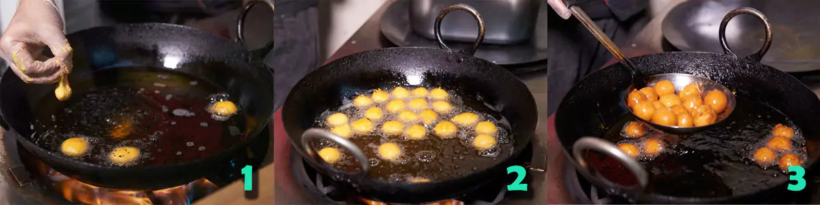 Fry the dough balls in oil and move them around using a frying ladle.